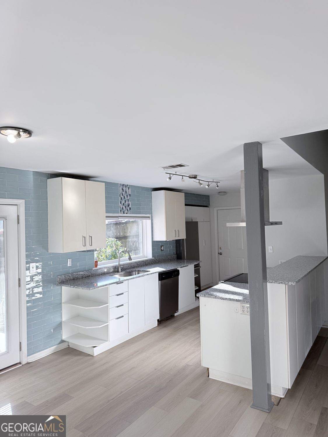 477 Benton Court Southwest Lawrenceville, GA 30044 - Photo 9 of 17 a large kitchen with cabinets and wooden floor