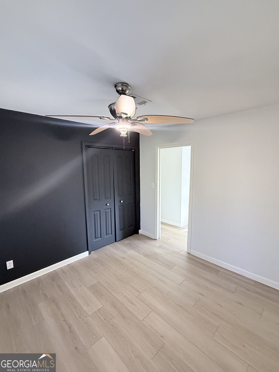 477 Benton Court Southwest Lawrenceville, GA 30044 - Photo 10 of 17 a view of an empty room with a chandelier fan