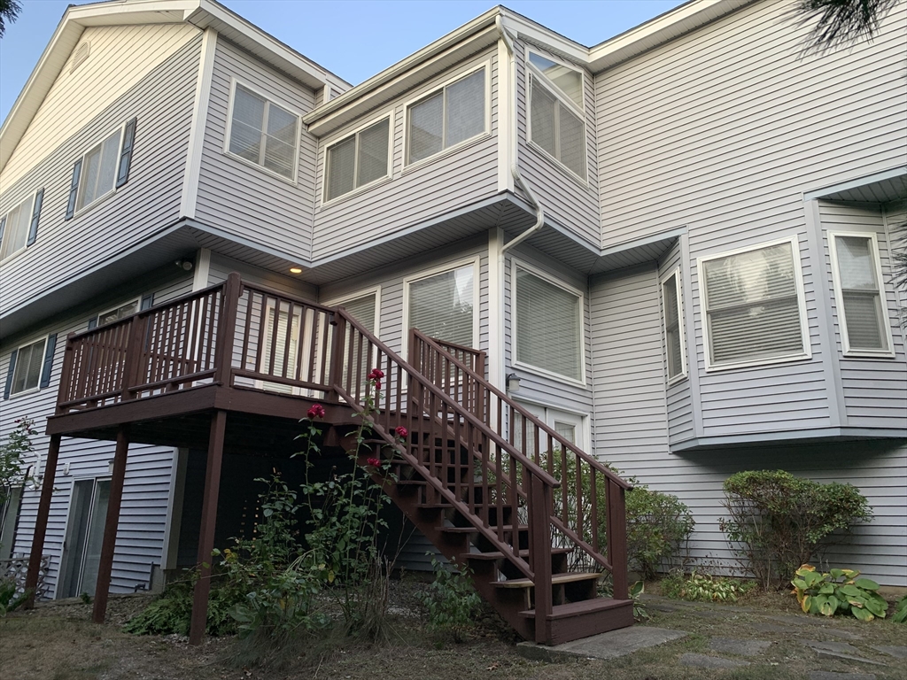 73 Half Crown Circle, Unit 73 Ashland, MA 01721 - Photo 1 of 18 a front view of a house with a yard