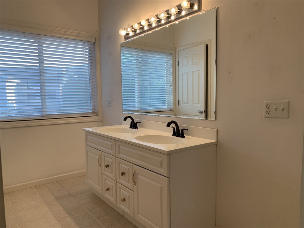 73 Half Crown Circle, Unit 73 Ashland, MA 01721 - Photo 15 of 18 a bathroom with a sink and a mirror