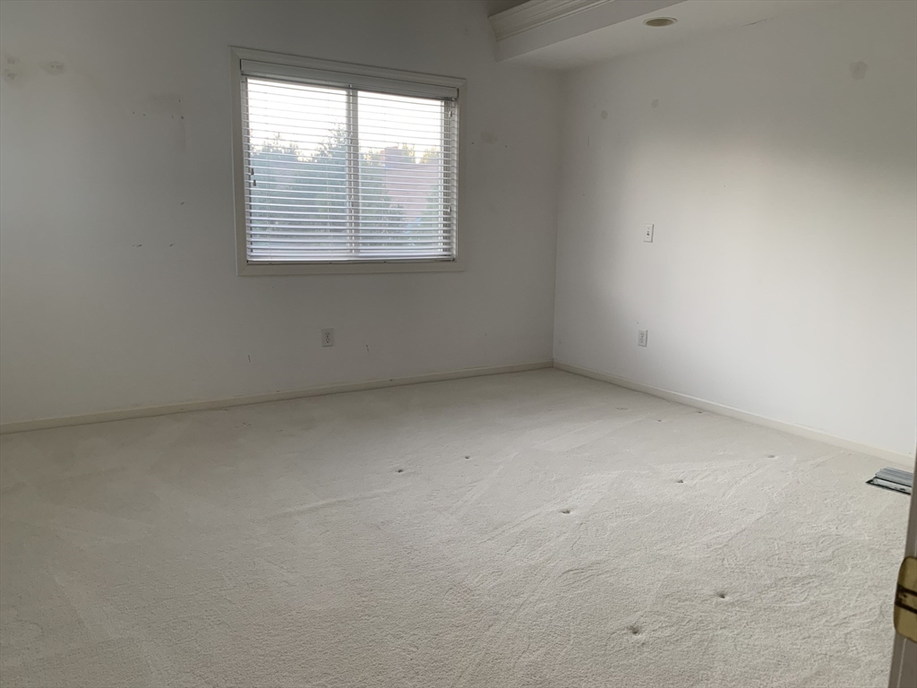 73 Half Crown Circle, Unit 73 Ashland, MA 01721 - Photo 17 of 18 an empty room with a window
