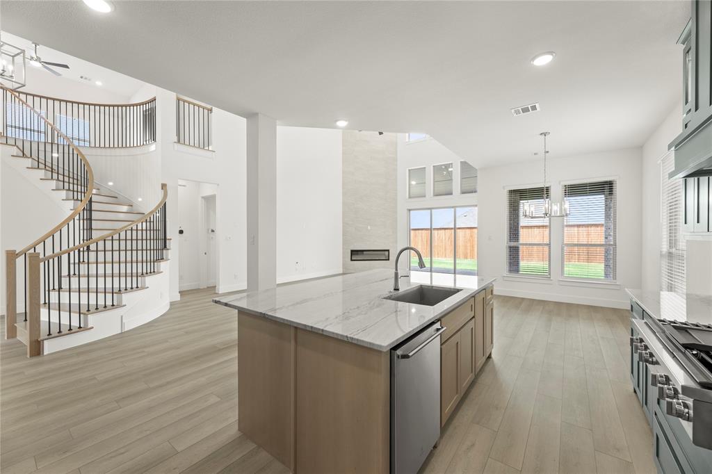 971 Georgetown Place Prosper, TX 75078 - Photo 18 of 34 a kitchen that has a lot of cabinets and wooden floor