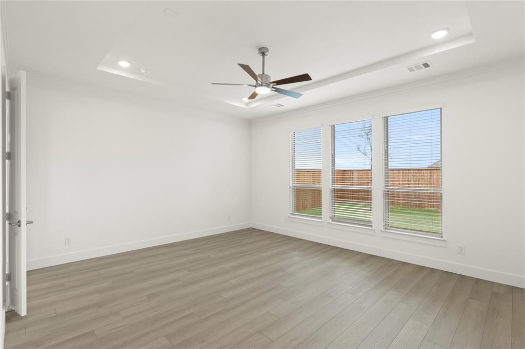 971 Georgetown Place Prosper, TX 75078 - Photo 21 of 34 an empty room with wooden floor chandelier fan and windows