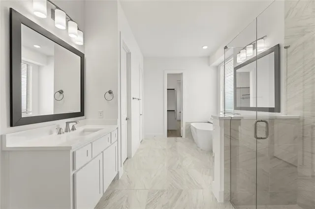 a bathroom with a double vanity sink mirror and shower
