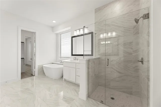 a bathroom with a granite countertop sink a toilet and shower