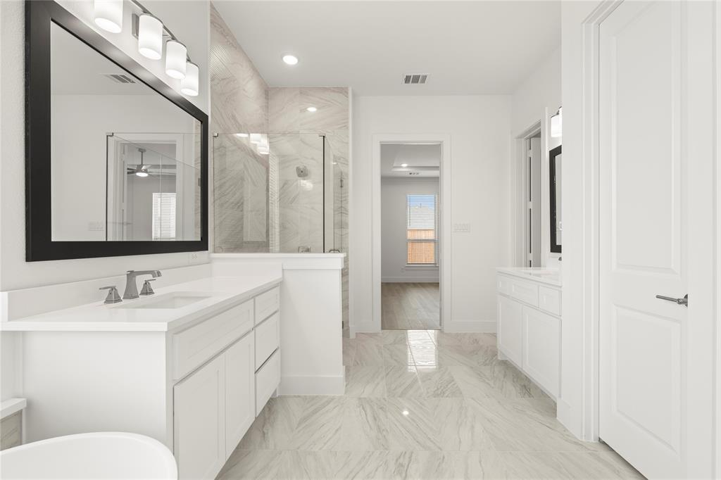 971 Georgetown Place Prosper, TX 75078 - Photo 26 of 34 a bathroom with a sink a toilet and shower