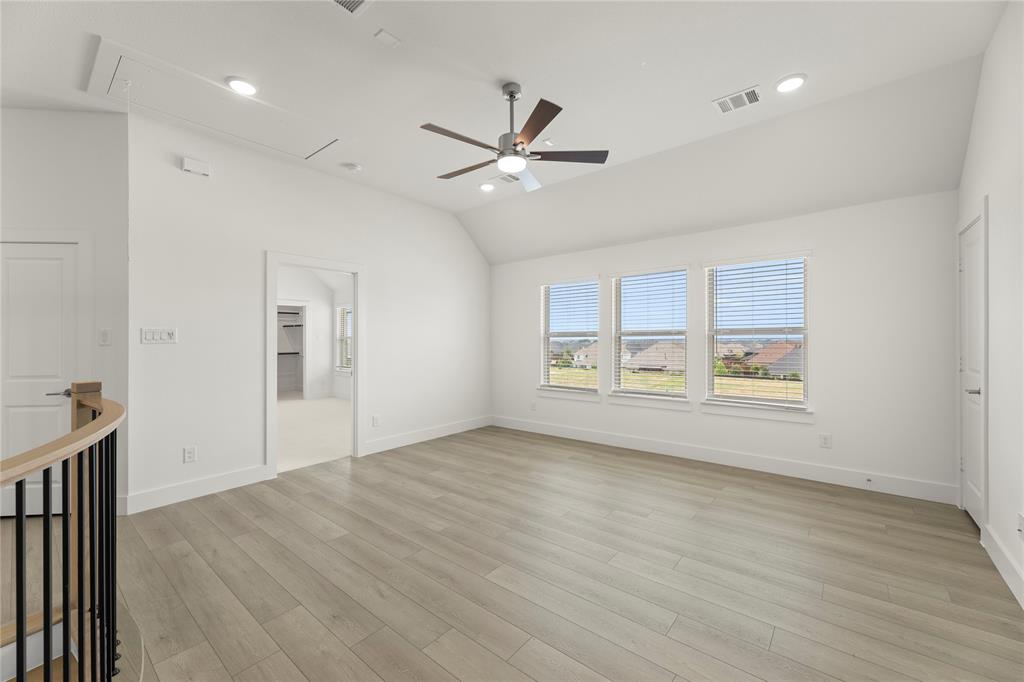 971 Georgetown Place Prosper, TX 75078 - Photo 28 of 34 a view of an empty room with a window and wooden floor