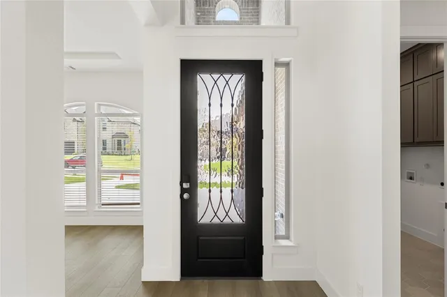 a view of a hallway with entryway door