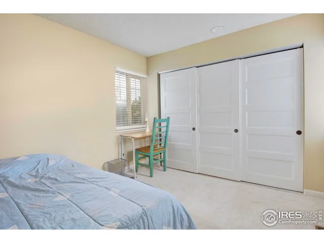 a bedroom with a bed and a table in it