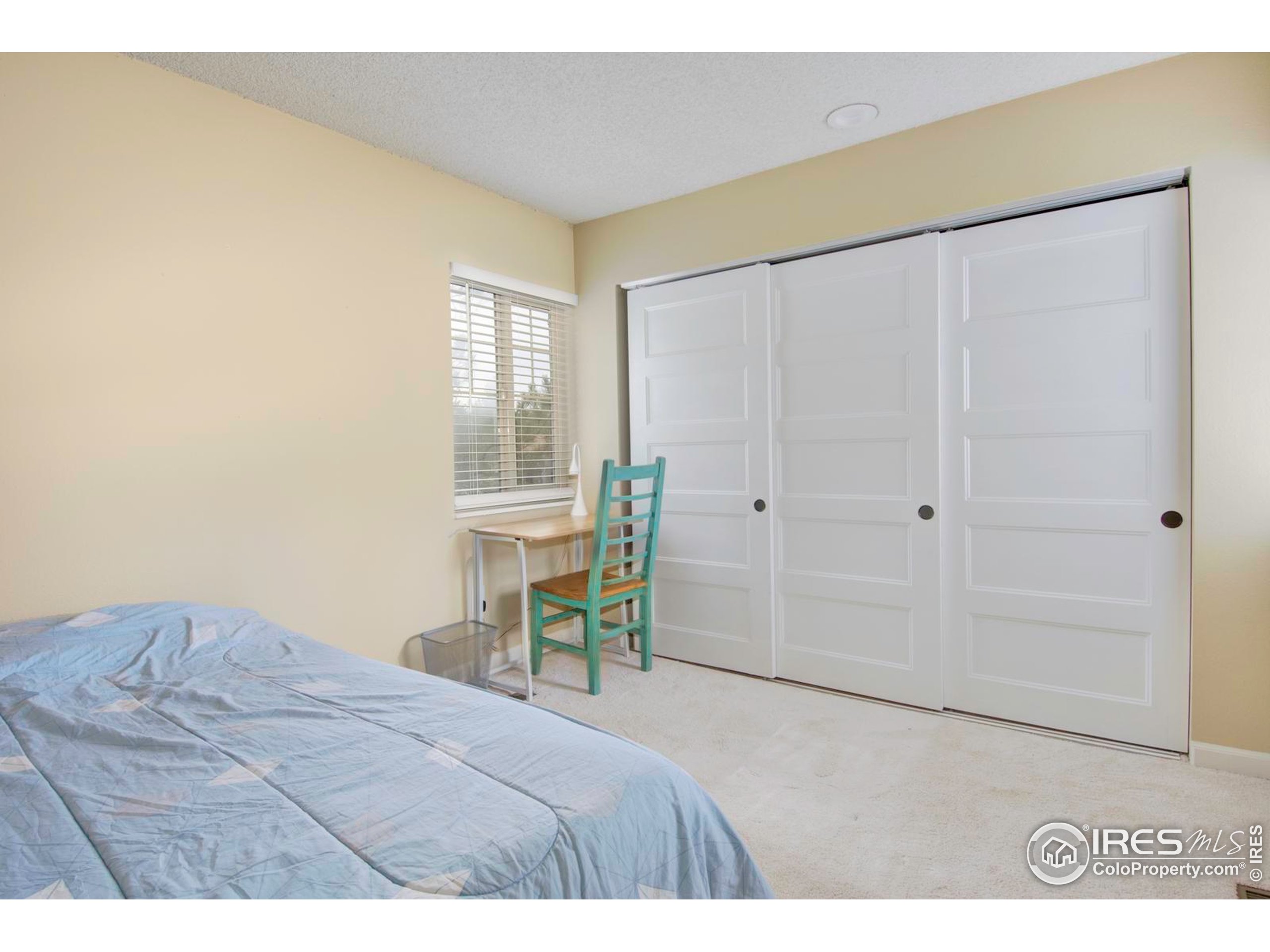 750 West Moorhead Circle, Unit A Boulder, CO 80305 - Photo 12 of 38 a bedroom with a bed and a table in it