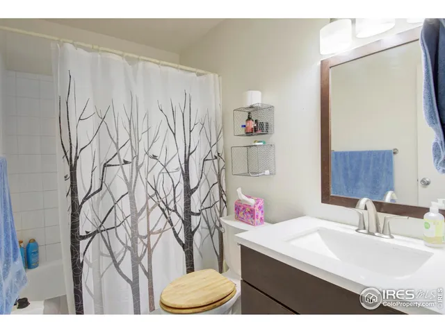 a bathroom with a sink vanity and a mirror