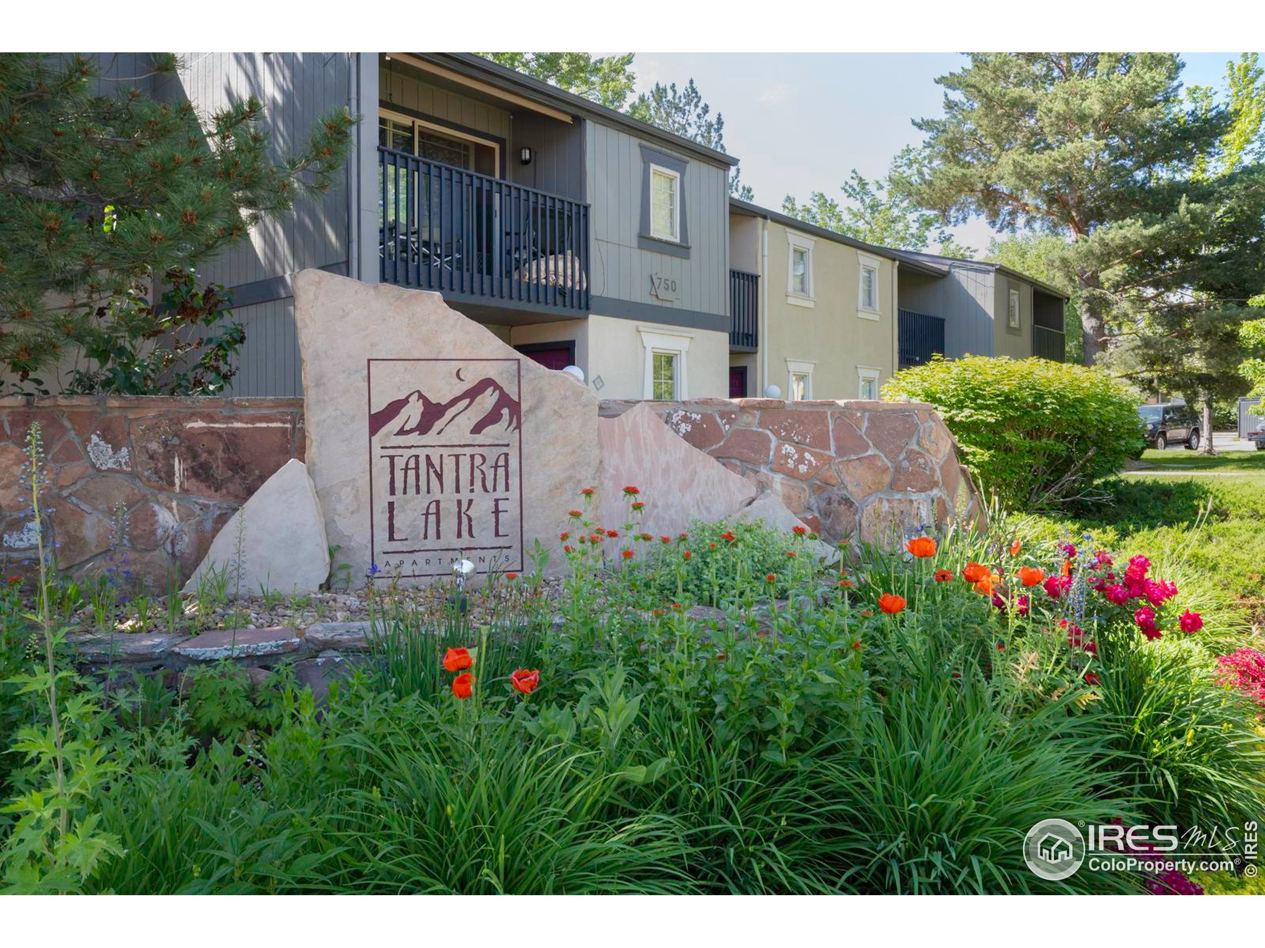 750 West Moorhead Circle, Unit A Boulder, CO 80305 - Photo 24 of 38 a view of a house with a yard and garden