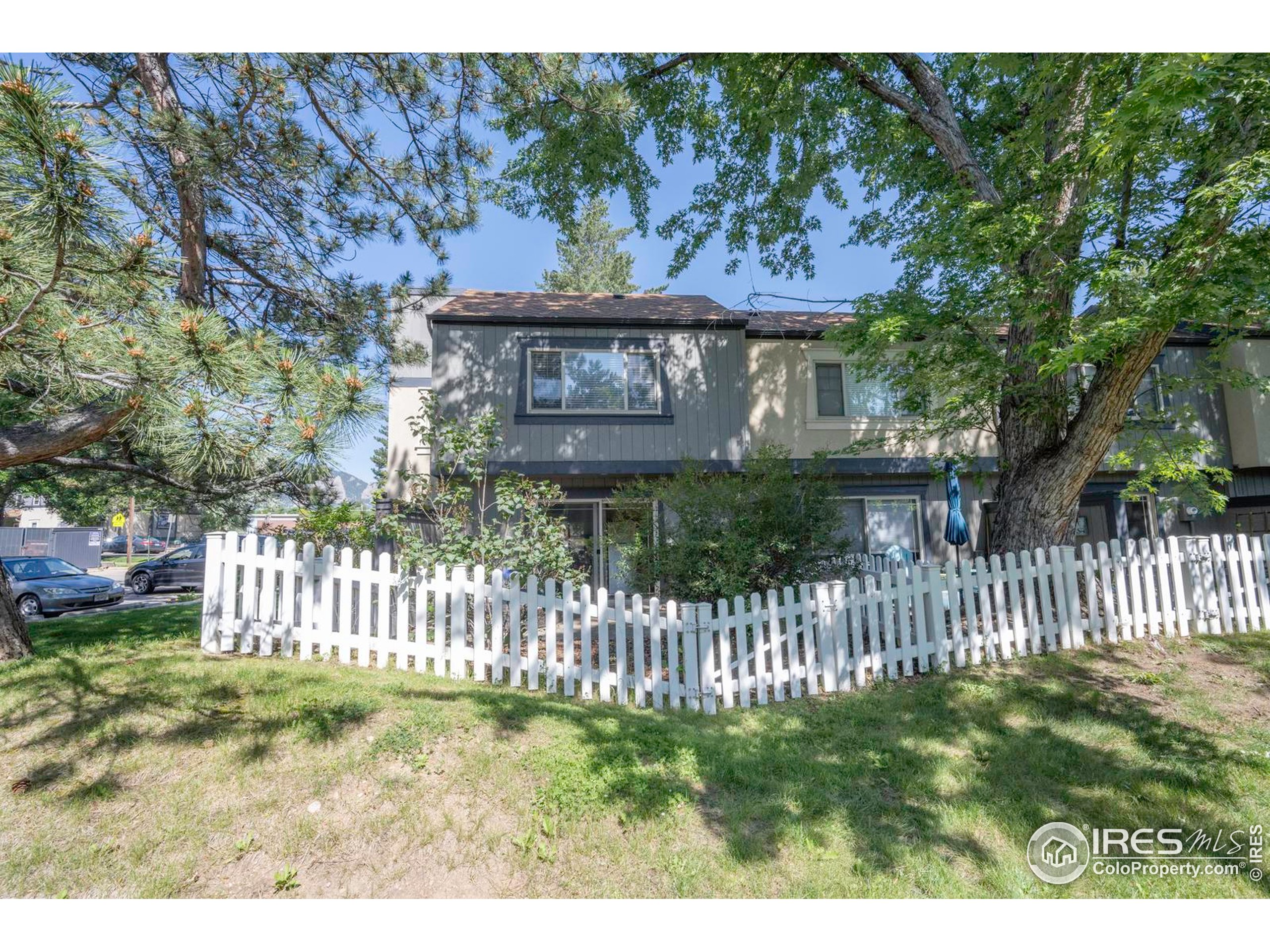 750 West Moorhead Circle, Unit A Boulder, CO 80305 - Photo 25 of 38 a view of a house with a small yard and wooden fence