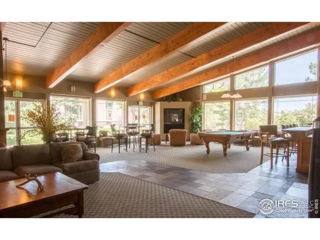 a living room with furniture a couch and large windows