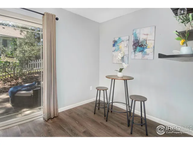 a view of a room with a table and chairs