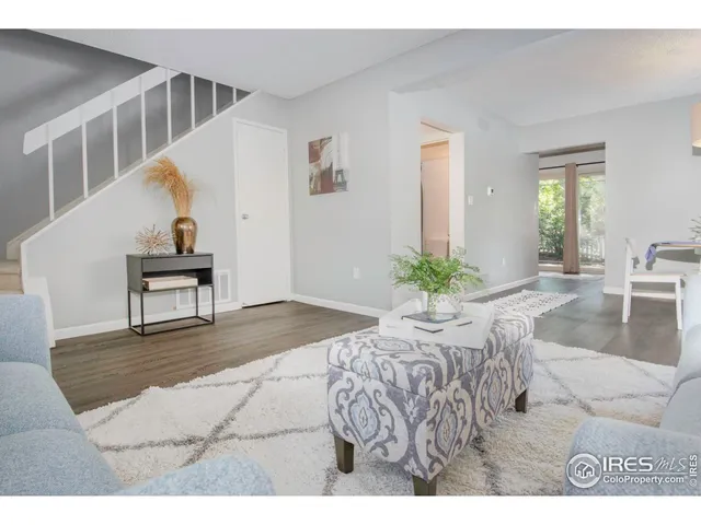 a view of living room filled with furniture and a potted plant