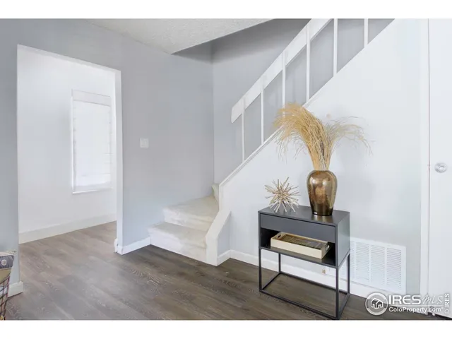 a view of wooden floor and windows in a room