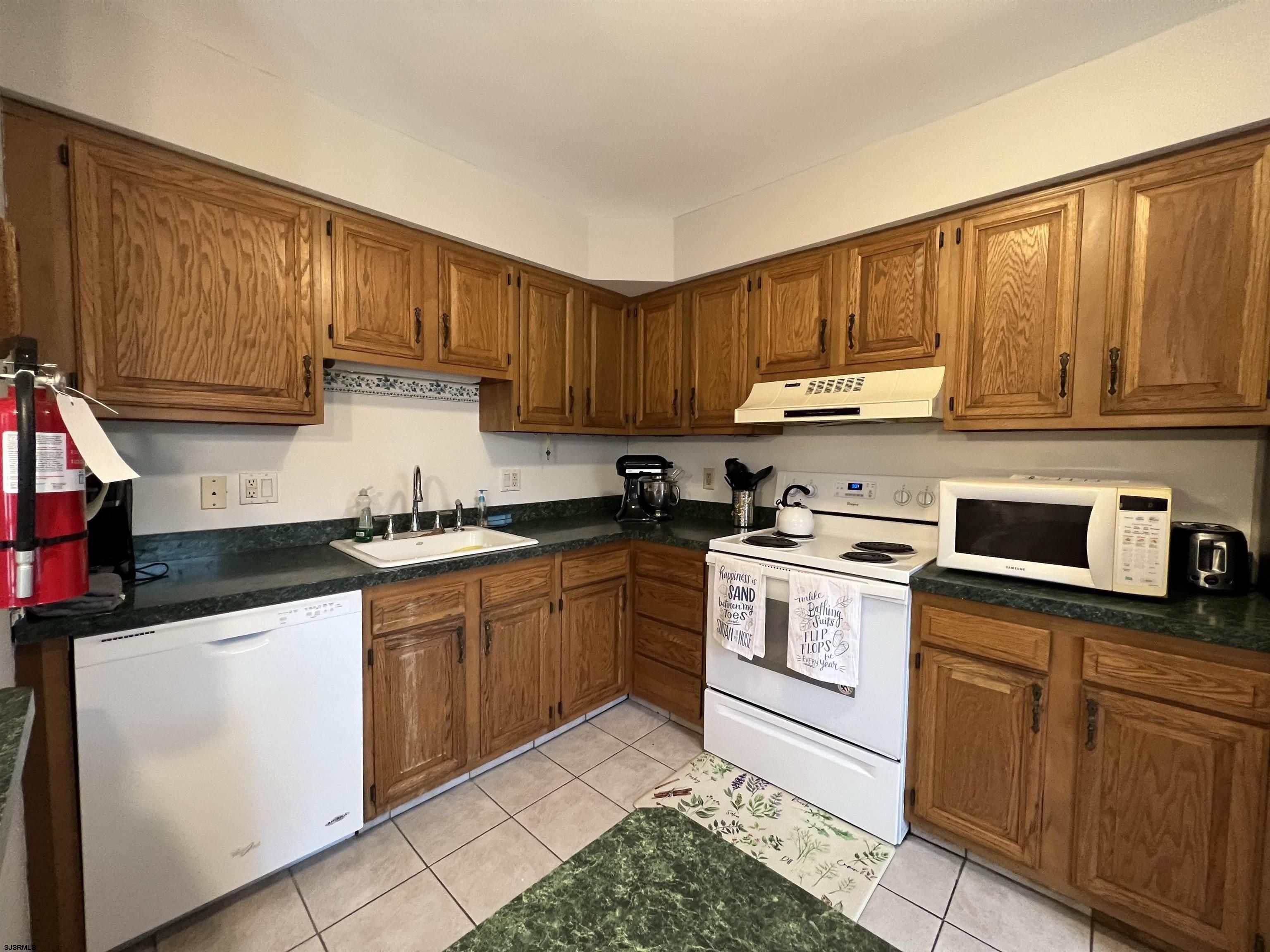 11 Surfside Road, Unit 11 Brigantine, NJ 08203 - Photo 12 of 21 a kitchen with cabinets appliances a sink and a counter space