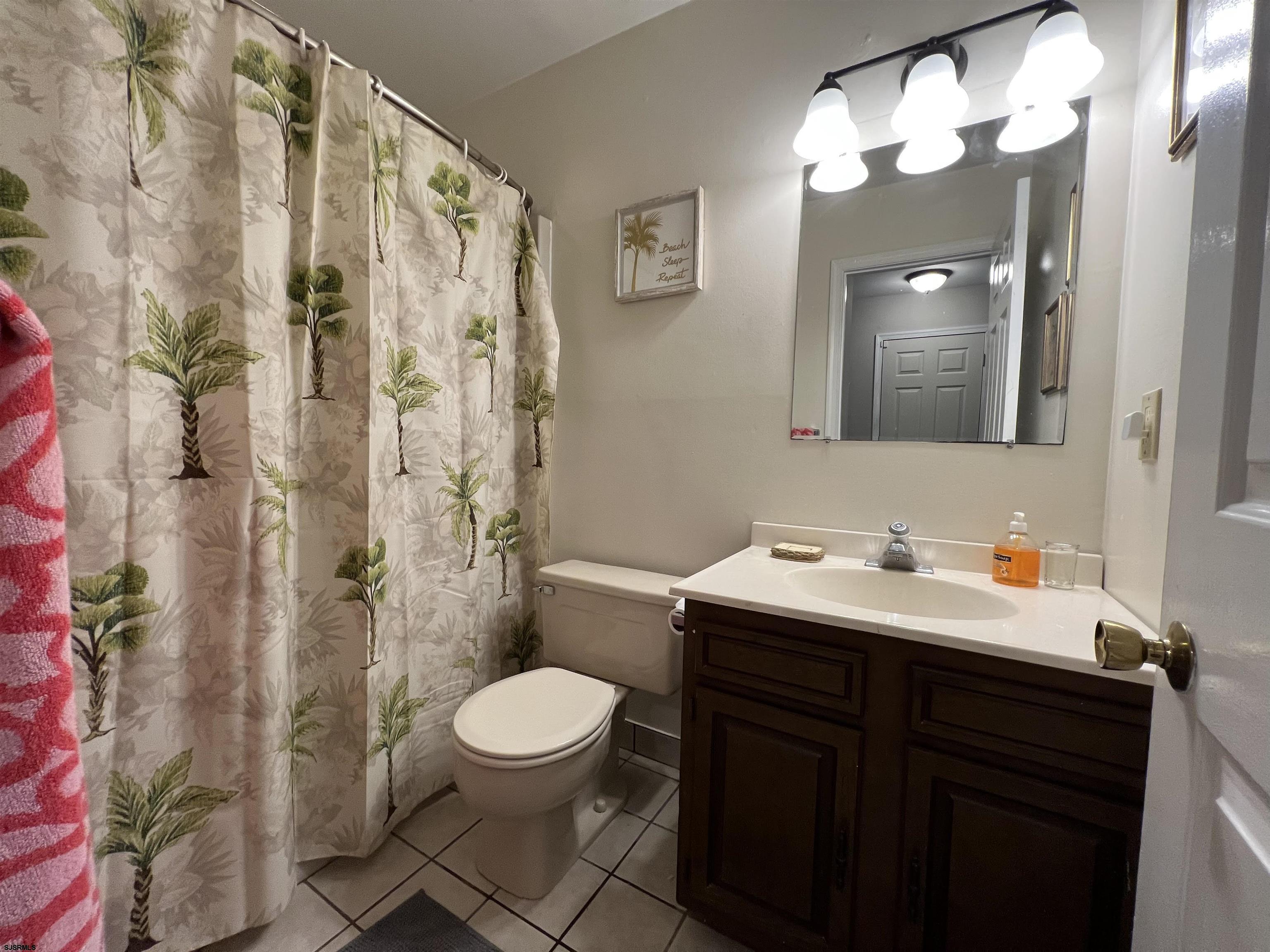 11 Surfside Road, Unit 11 Brigantine, NJ 08203 - Photo 13 of 21 a bathroom with a sink a toilet and shower