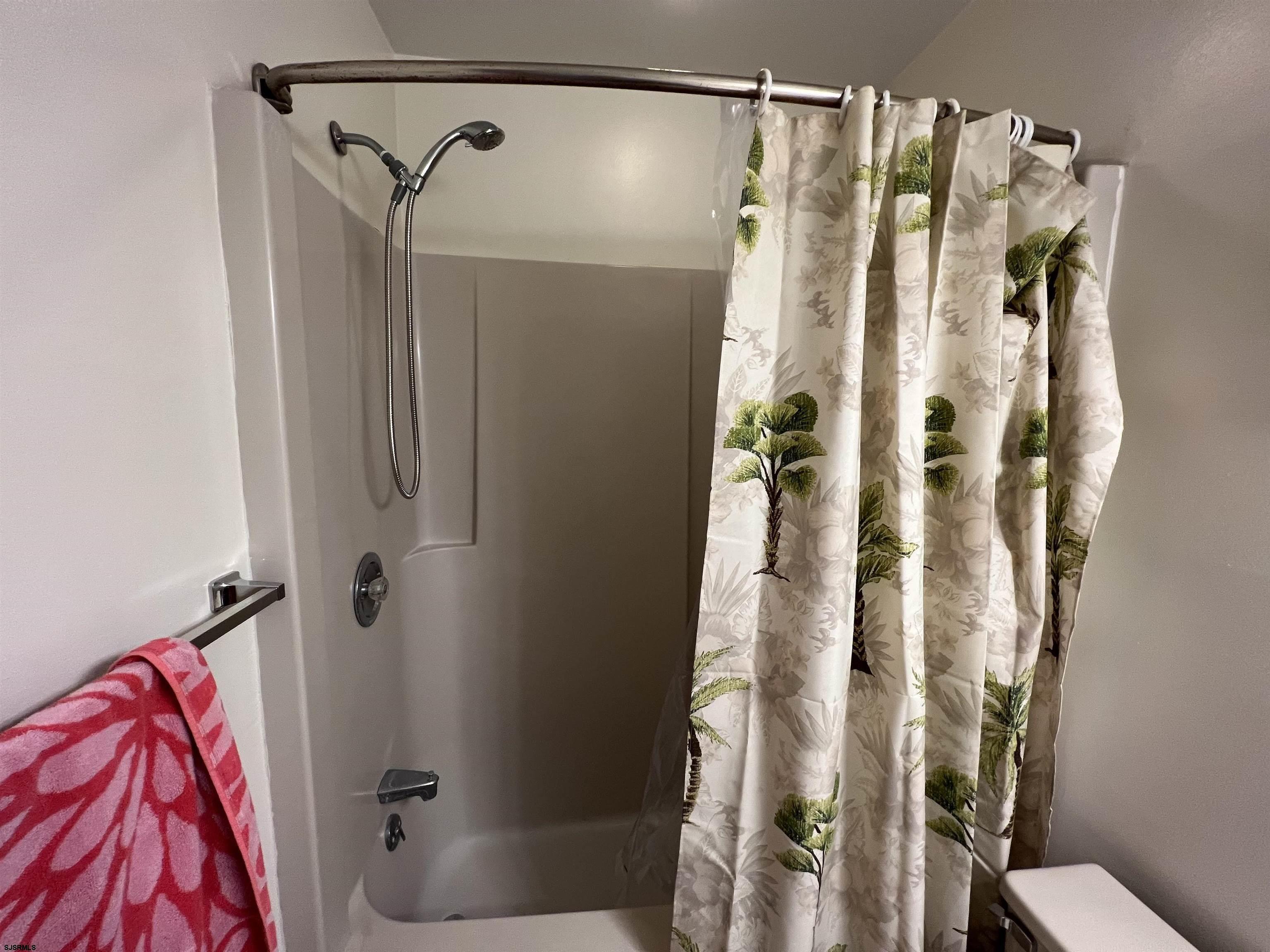 11 Surfside Road, Unit 11 Brigantine, NJ 08203 - Photo 15 of 21 a bathroom with a shower and a tub