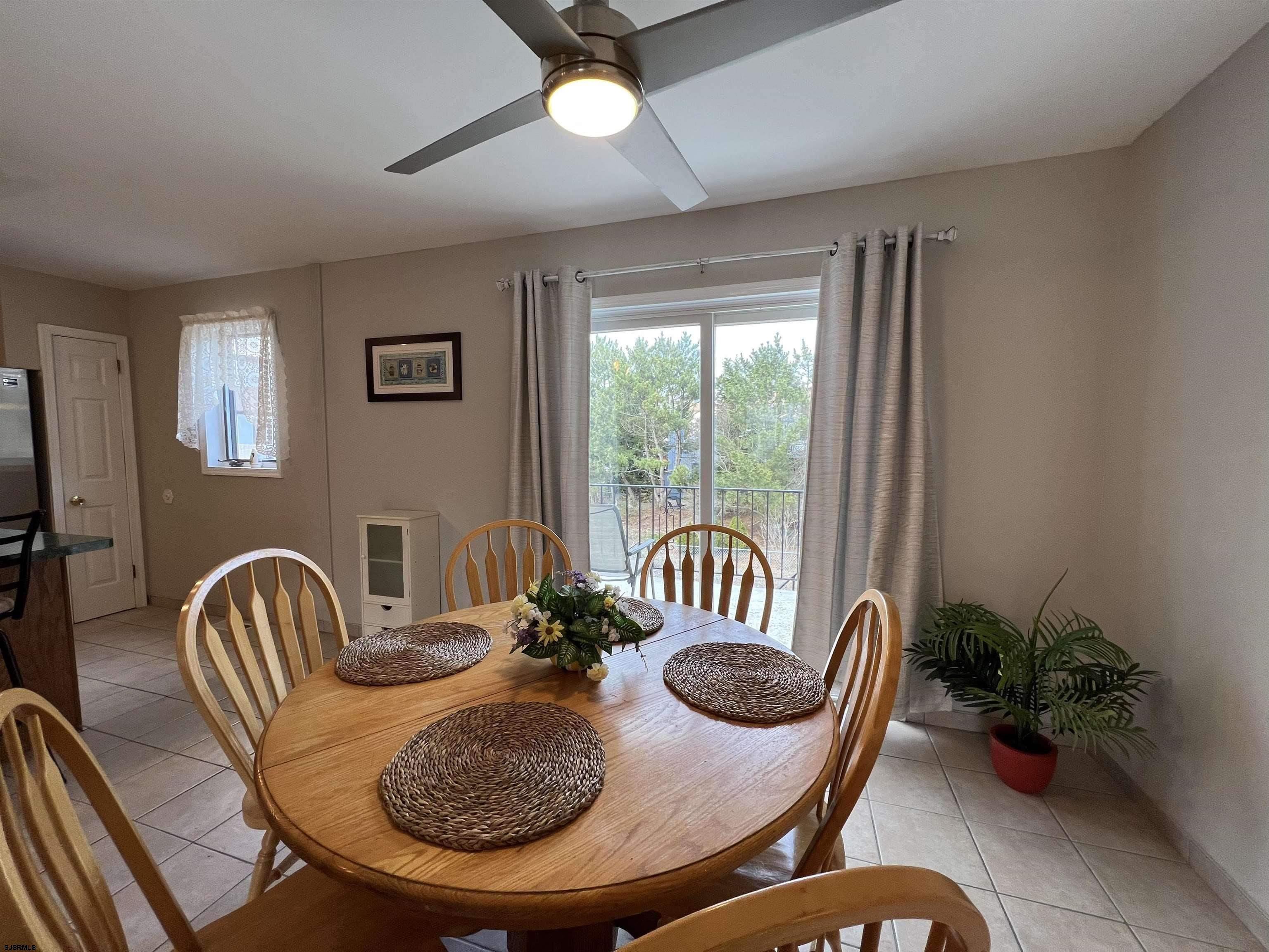 11 Surfside Road, Unit 11 Brigantine, NJ 08203 - Photo 17 of 21 a view of a dining room with furniture window and wooden floor