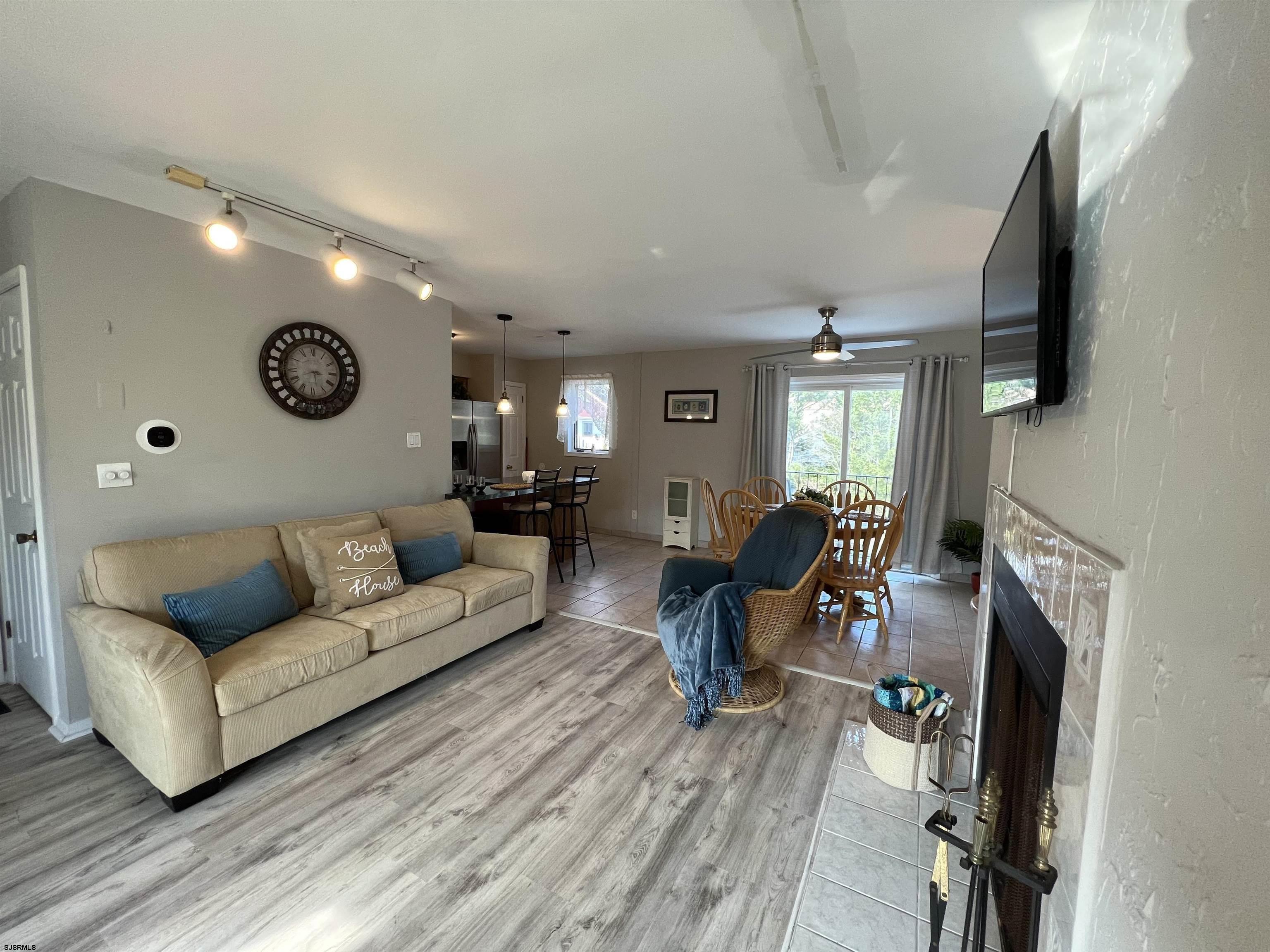 11 Surfside Road, Unit 11 Brigantine, NJ 08203 - Photo 2 of 21 a living room with furniture and a flat screen tv