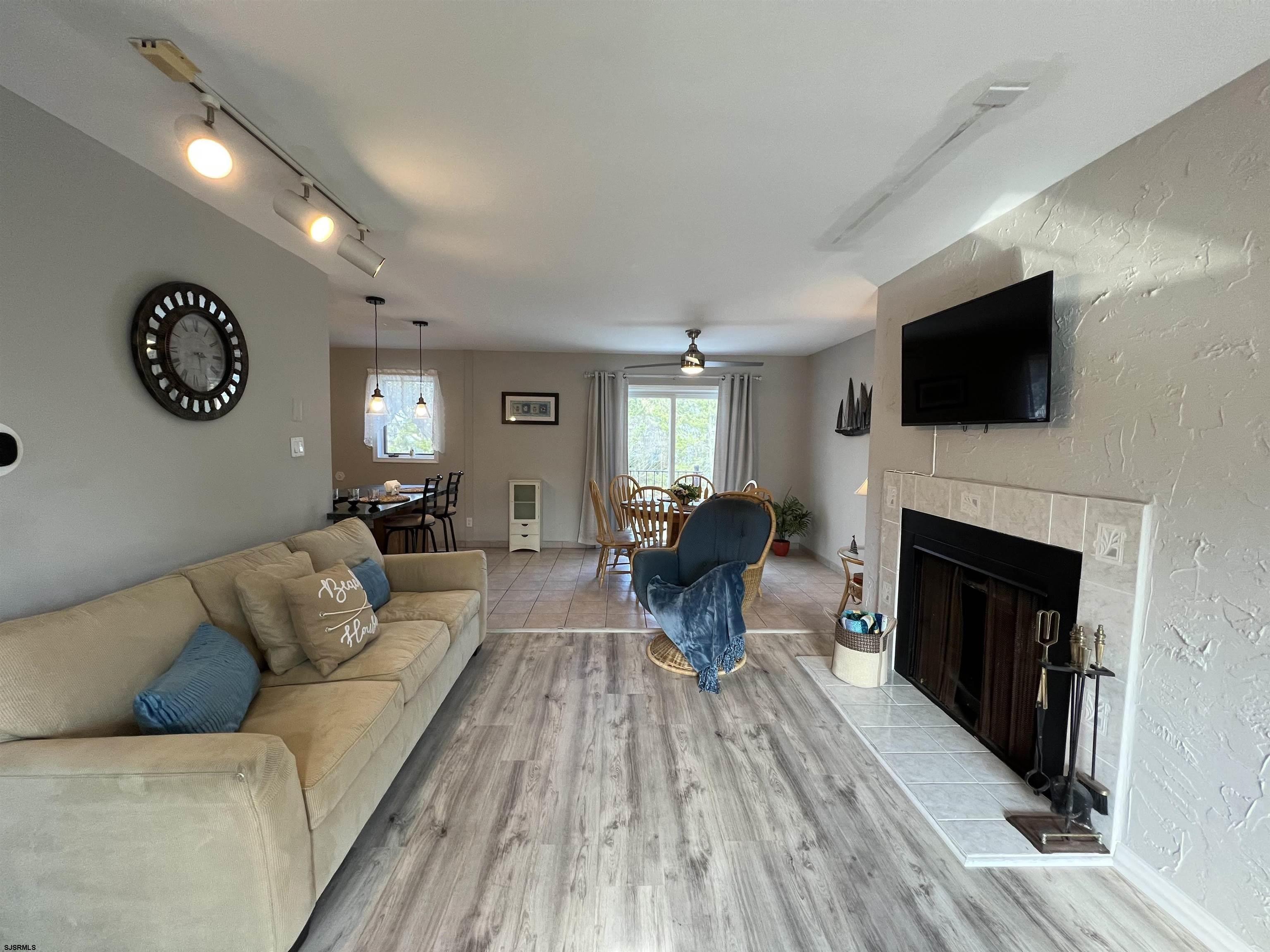 11 Surfside Road, Unit 11 Brigantine, NJ 08203 - Photo 3 of 21 a living room with furniture a flat screen tv and a fireplace