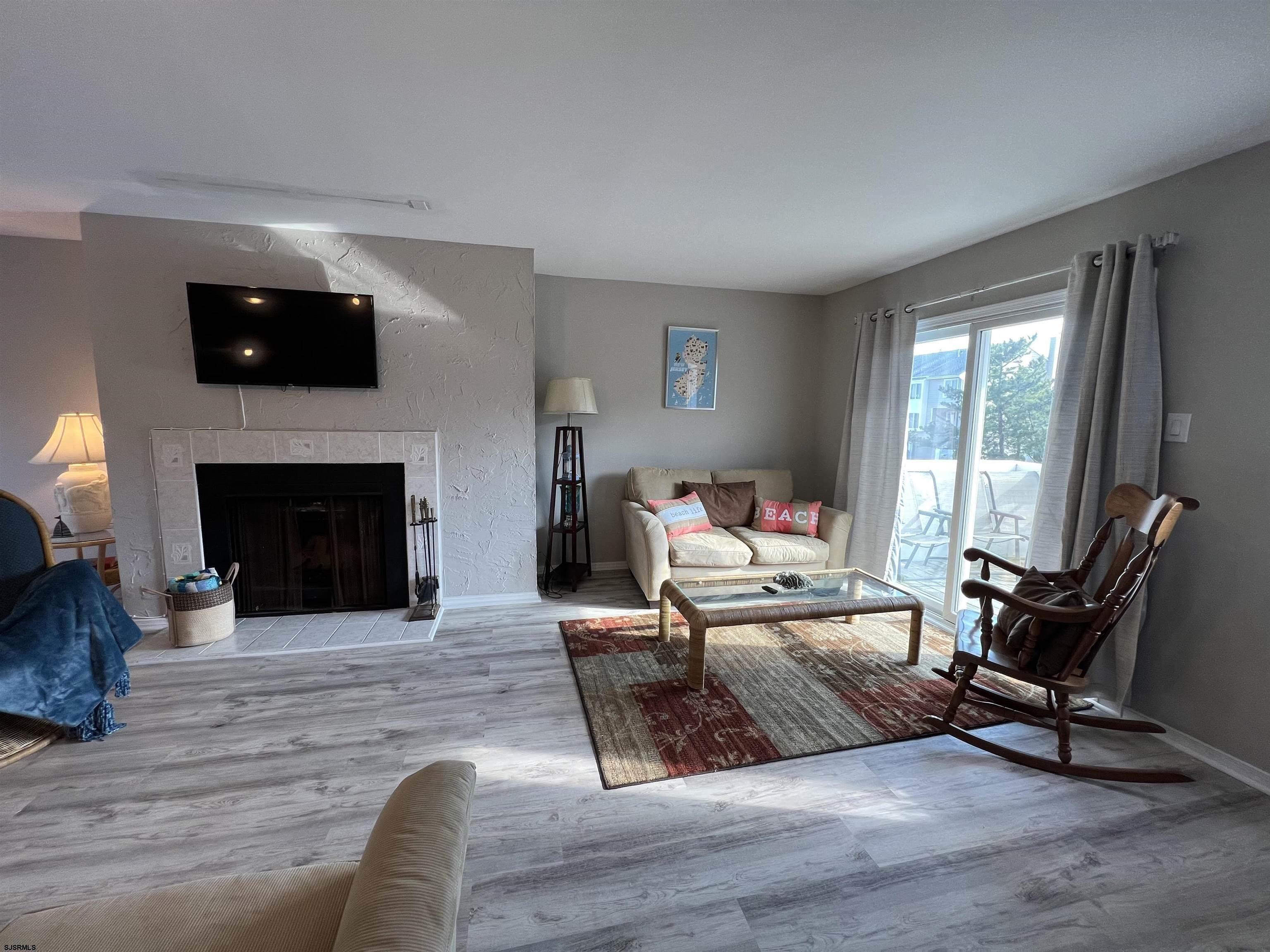 11 Surfside Road, Unit 11 Brigantine, NJ 08203 - Photo 4 of 21 a living room with furniture and a fireplace