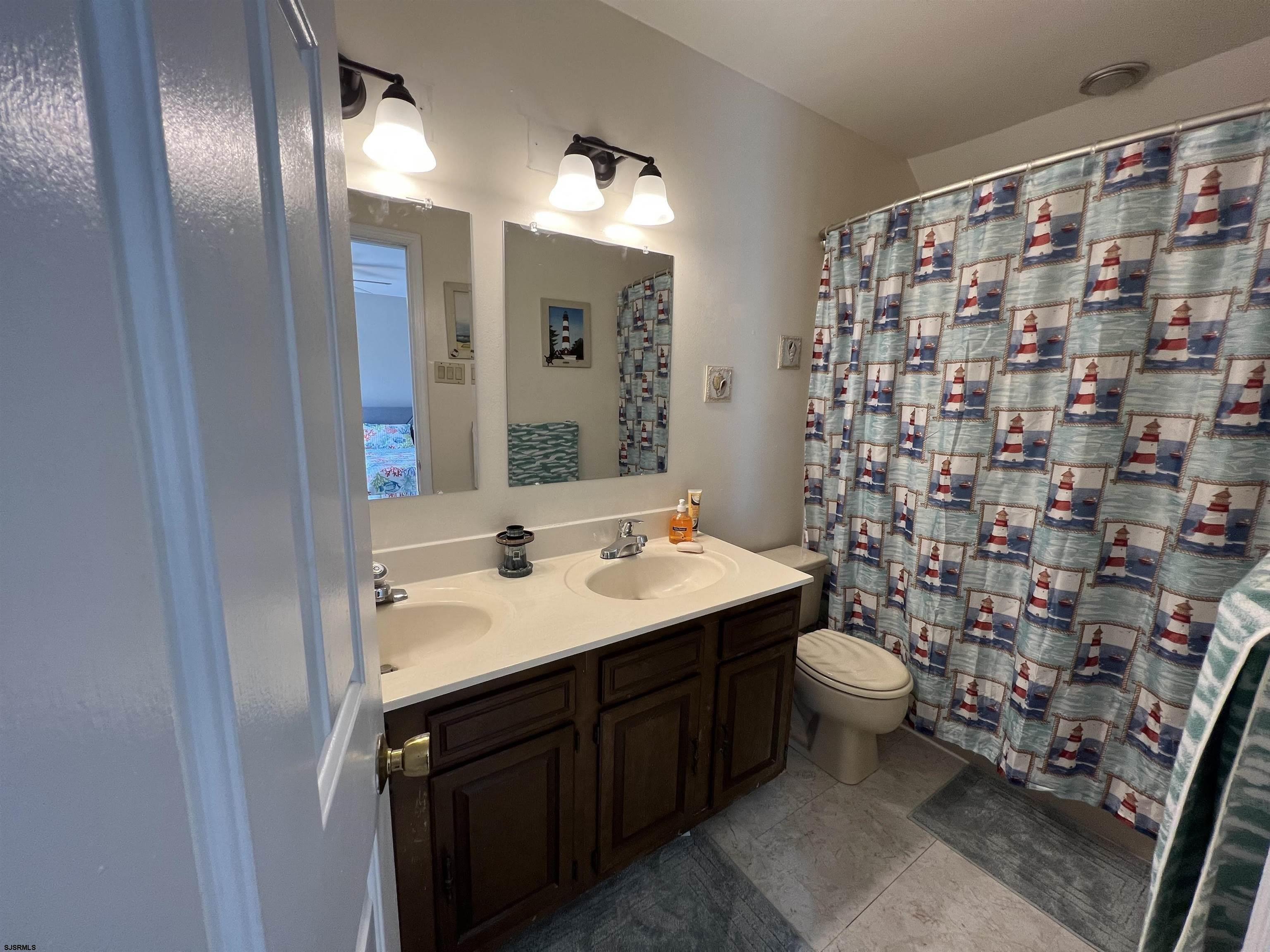 11 Surfside Road, Unit 11 Brigantine, NJ 08203 - Photo 8 of 21 a bathroom with a sink toilet and shower