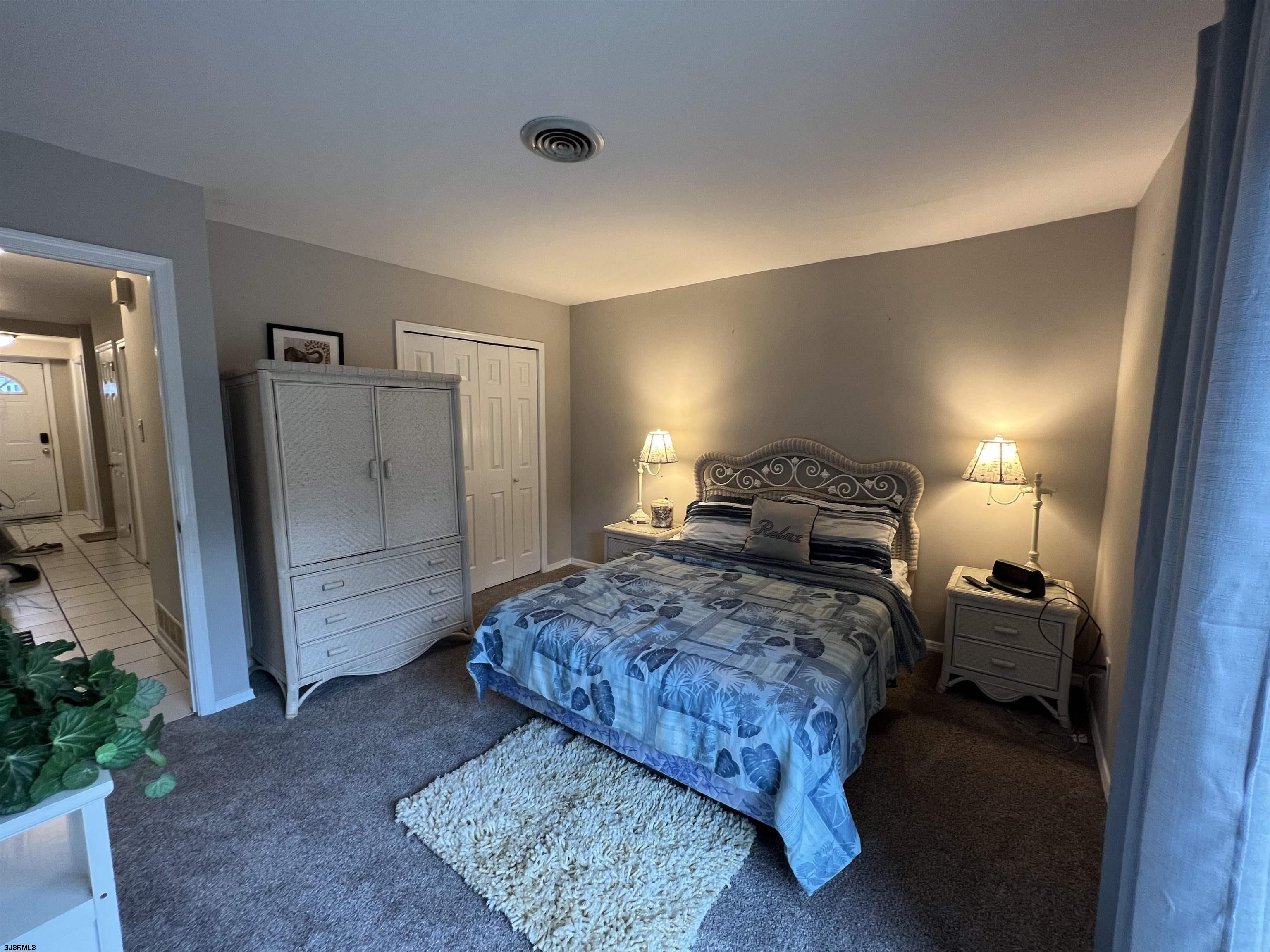 11 Surfside Road, Unit 11 Brigantine, NJ 08203 - Photo 10 of 21 a bedroom with a bed and a refrigerator