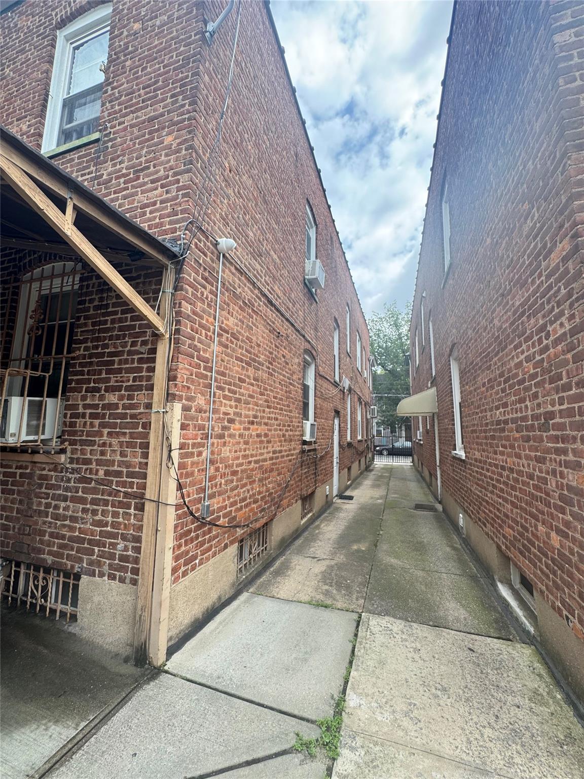 88-16 85th Street Queens, NY 11421 - Photo 7 of 11 View of property exterior with brick siding