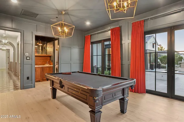 a room with pool table and windows