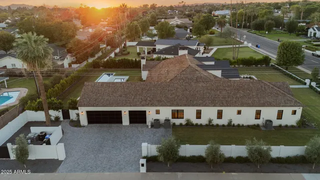 an aerial view of house with yard space and lake view in back