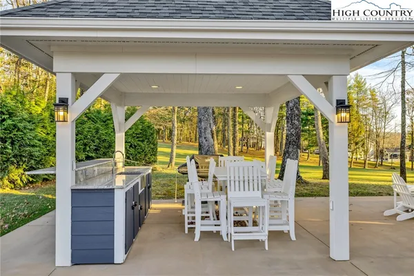 a living room with patio furniture and a floor to ceiling window