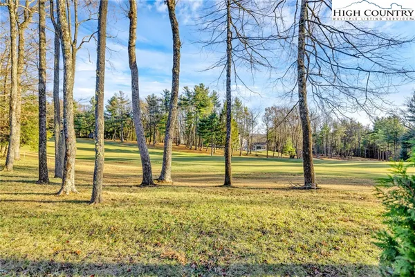 a view of backyard with swimming pool and outdoor seating