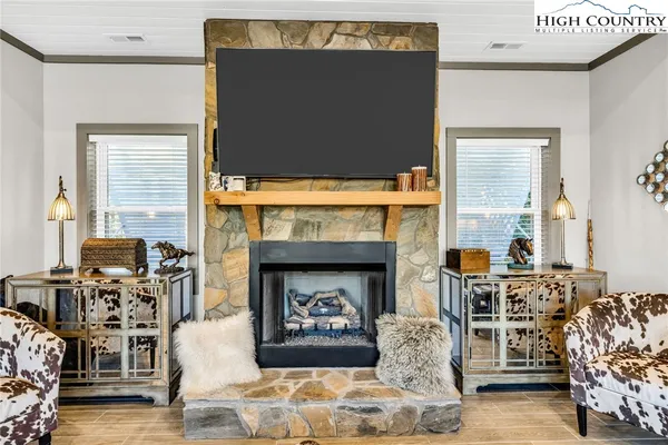 a living room with fireplace furniture and a flat screen tv
