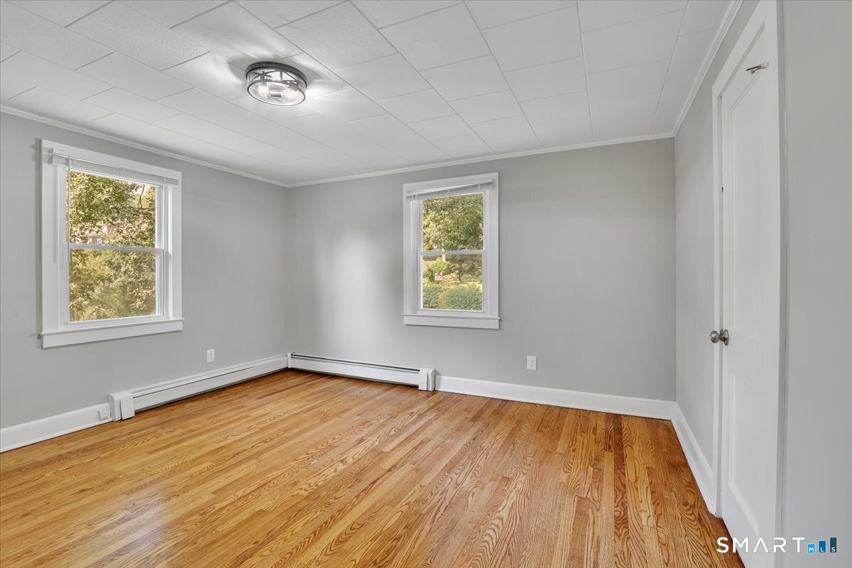 16 Strong Street Burlington, CT 06013 - Photo 14 of 36 an empty room with wooden floor and windows