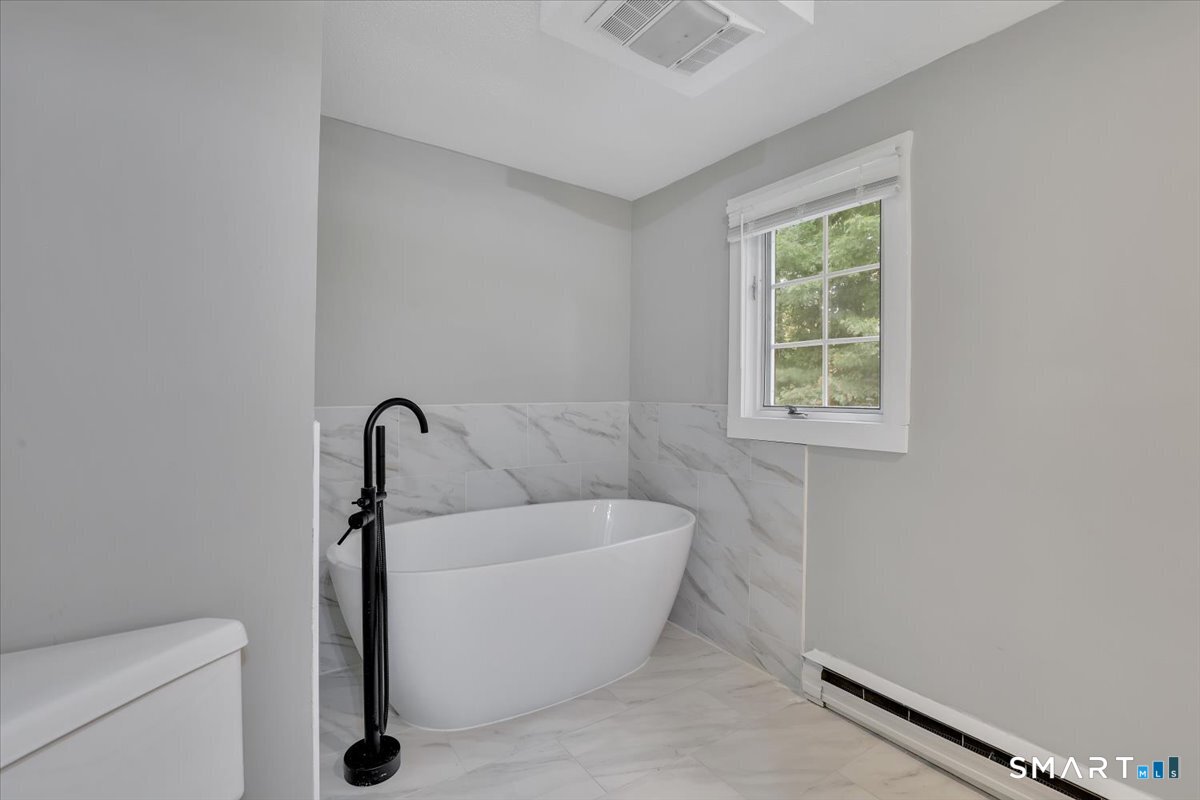 16 Strong Street Burlington, CT 06013 - Photo 21 of 36 a white bath tub sitting next to a white toilet