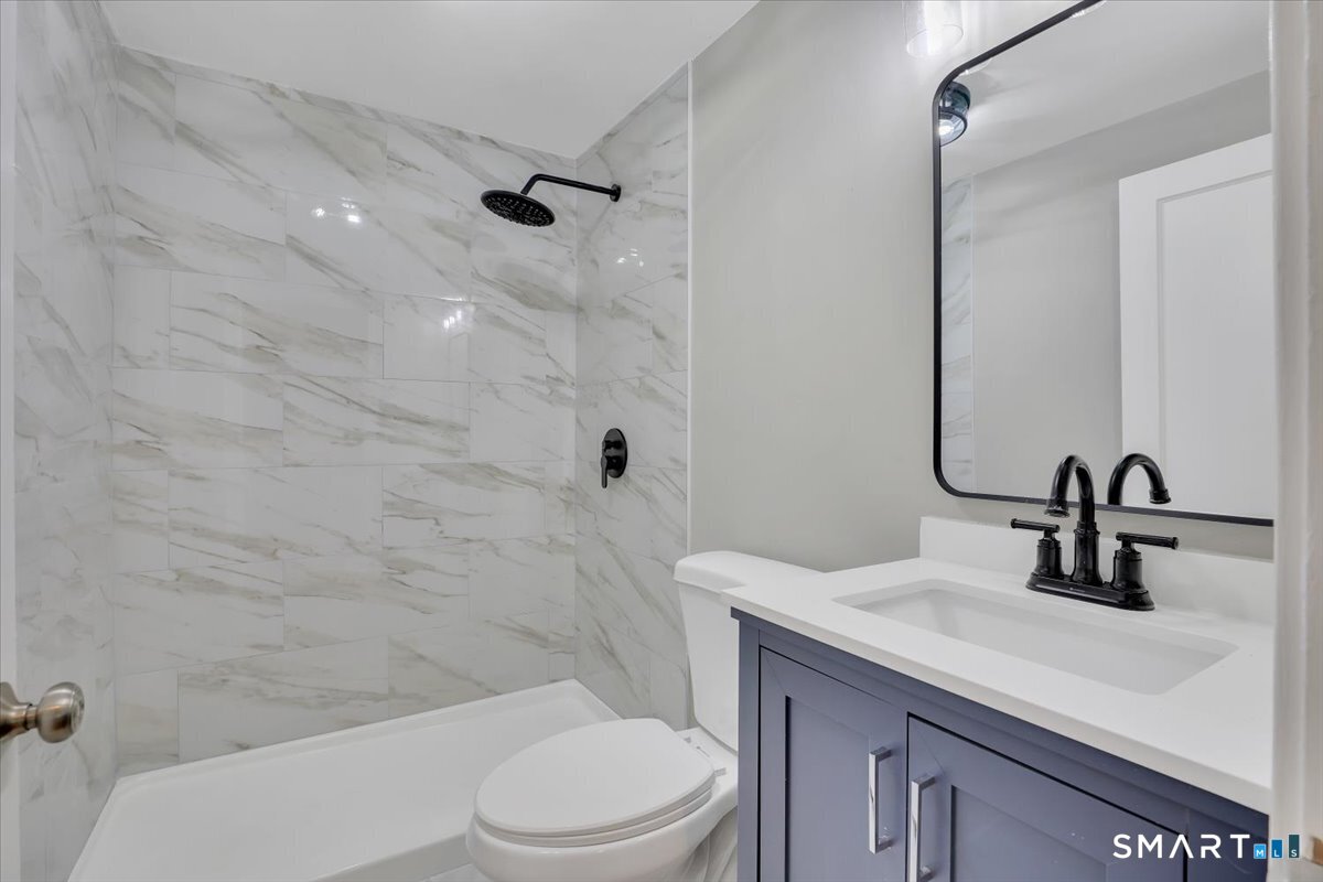 16 Strong Street Burlington, CT 06013 - Photo 23 of 36 a bathroom with a sink a toilet and shower