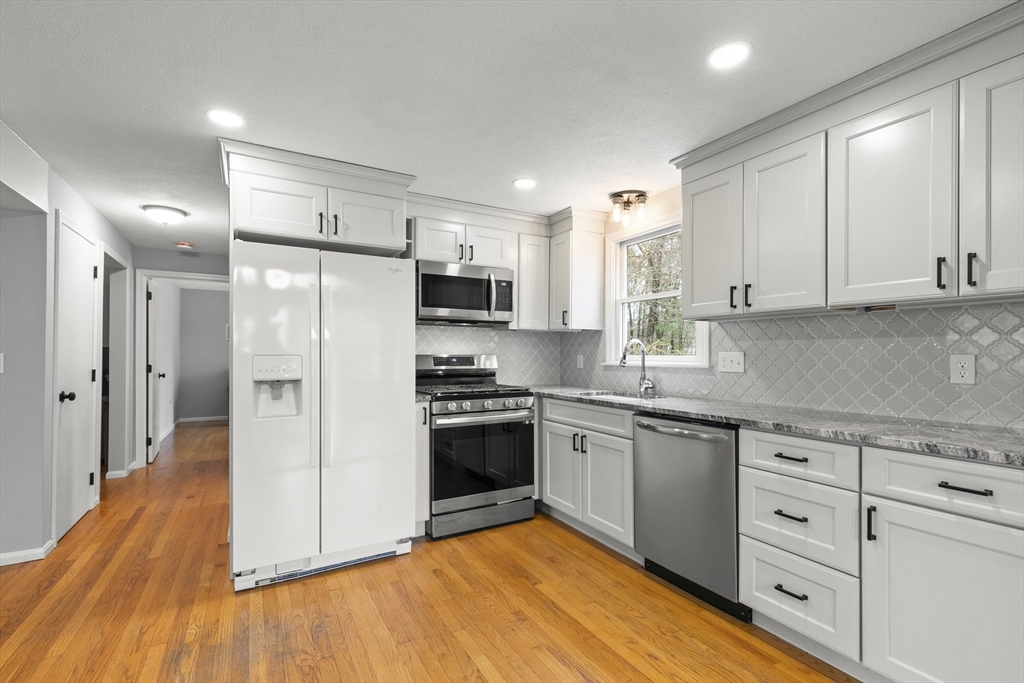 36 Emery Road Townsend, MA 01469 - Photo 13 of 40 a kitchen with stainless steel appliances granite countertop a stove a sink and a refrigerator