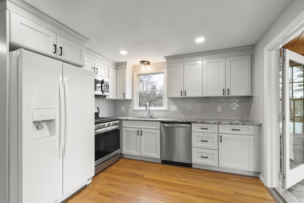 36 Emery Road Townsend, MA 01469 - Photo 14 of 40 a kitchen with granite countertop white cabinets and white stainless steel appliances