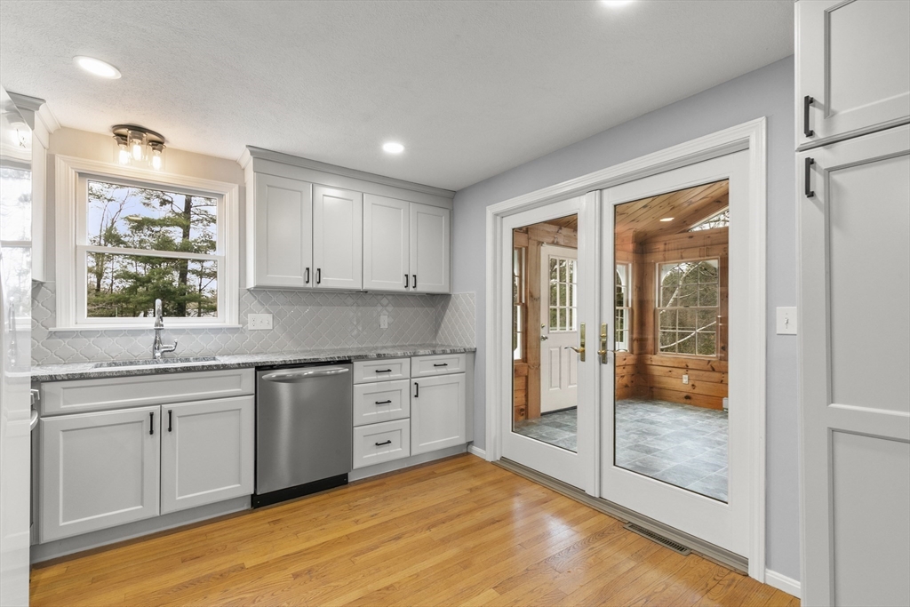36 Emery Road Townsend, MA 01469 - Photo 15 of 40 a large kitchen with stainless steel appliances granite countertop a sink and cabinets with wooden floor