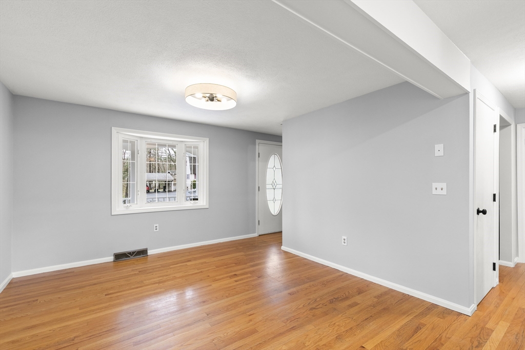 36 Emery Road Townsend, MA 01469 - Photo 18 of 40 a view of an empty room with wooden floor and a window