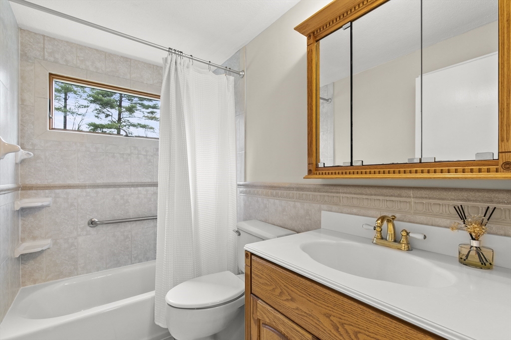 36 Emery Road Townsend, MA 01469 - Photo 27 of 40 a bathroom with a granite countertop sink a toilet and shower