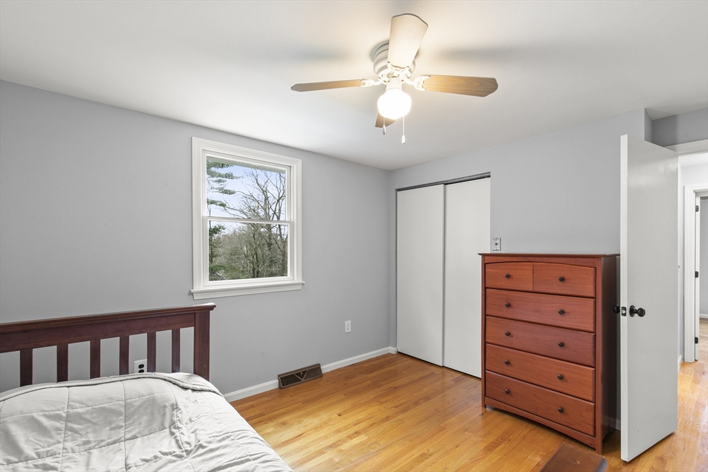 36 Emery Road Townsend, MA 01469 - Photo 39 of 40 a bedroom with a bed and a chandelier