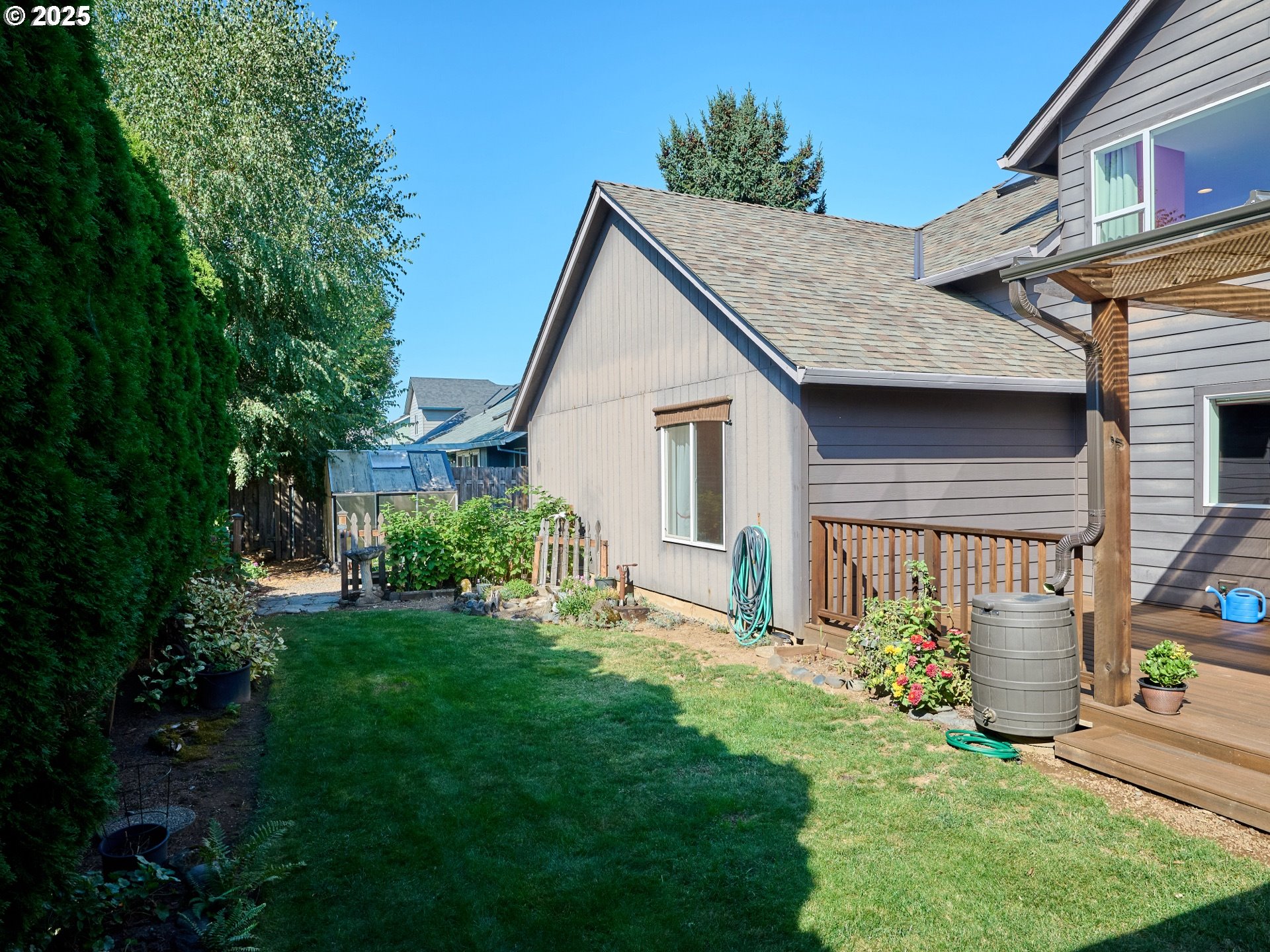 331 Southeast 9th Avenue Canby, OR 97013 - Photo 32 of 35 a view of a house with brick walls and a yard with potted plants