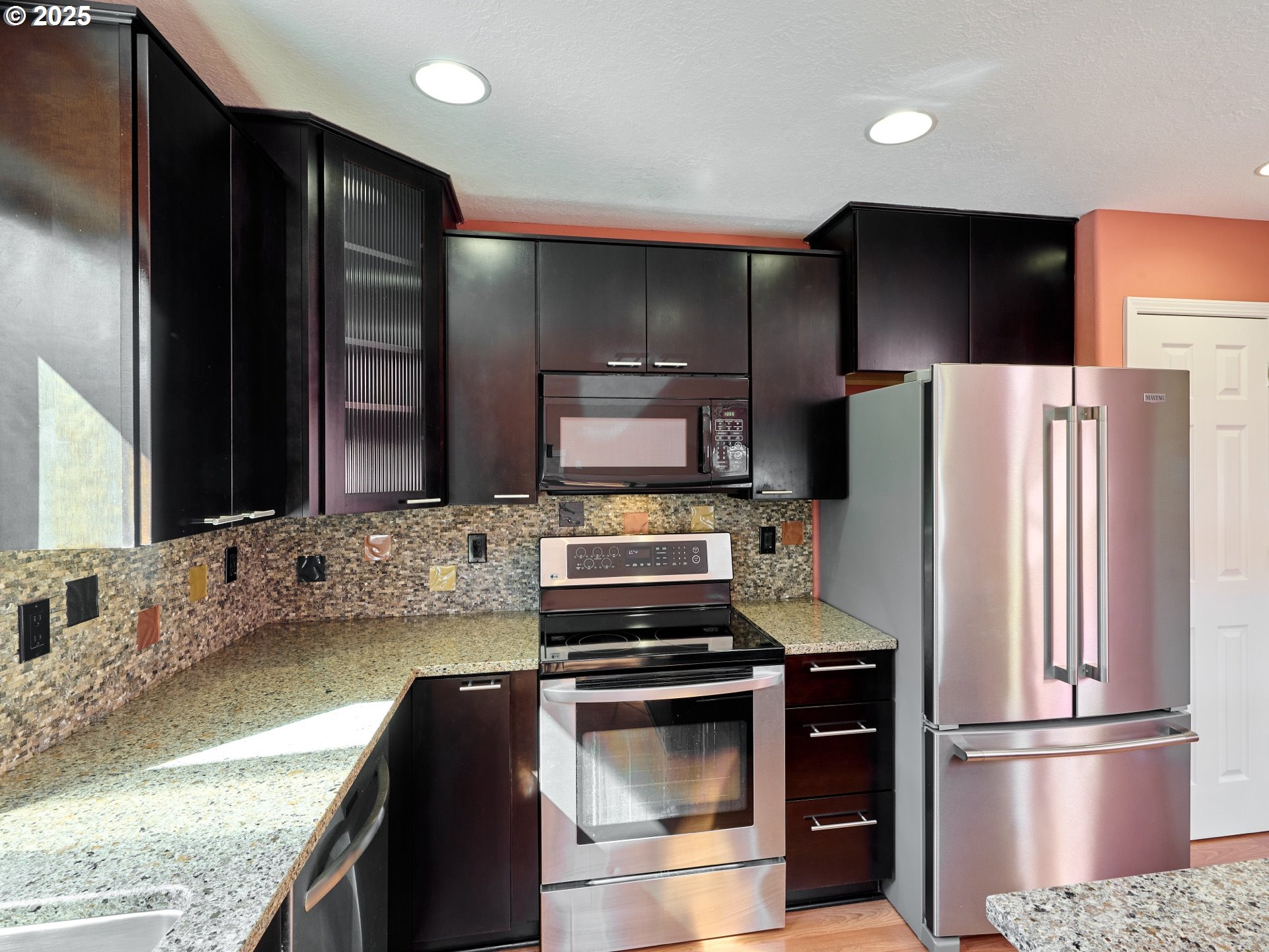 331 Southeast 9th Avenue Canby, OR 97013 - Photo 8 of 35 a kitchen with granite countertop a refrigerator and a stove top oven
