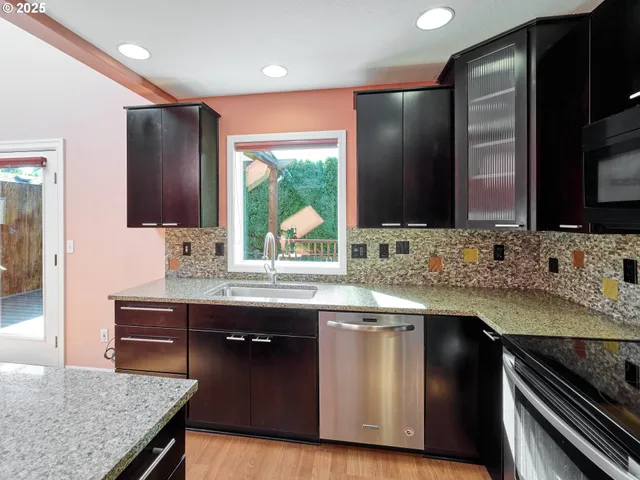 a kitchen with stainless steel appliances granite countertop counter space a sink and cabinets