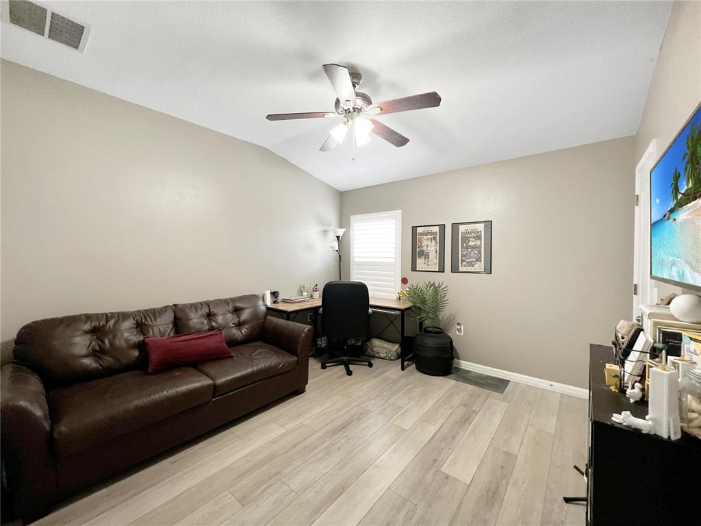 15767 Stable Run Drive Spring Hill, FL 34610 - Photo 26 of 34 a living room with furniture and a chandelier