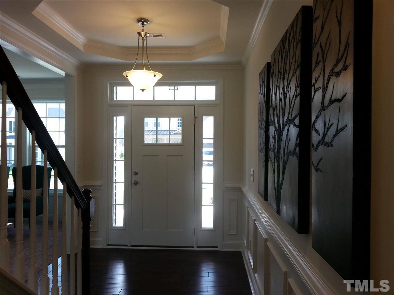 7516 Channery Way Raleigh, NC 27616 - Photo 2 of 25 a view of a hallway with wooden floor and staircase